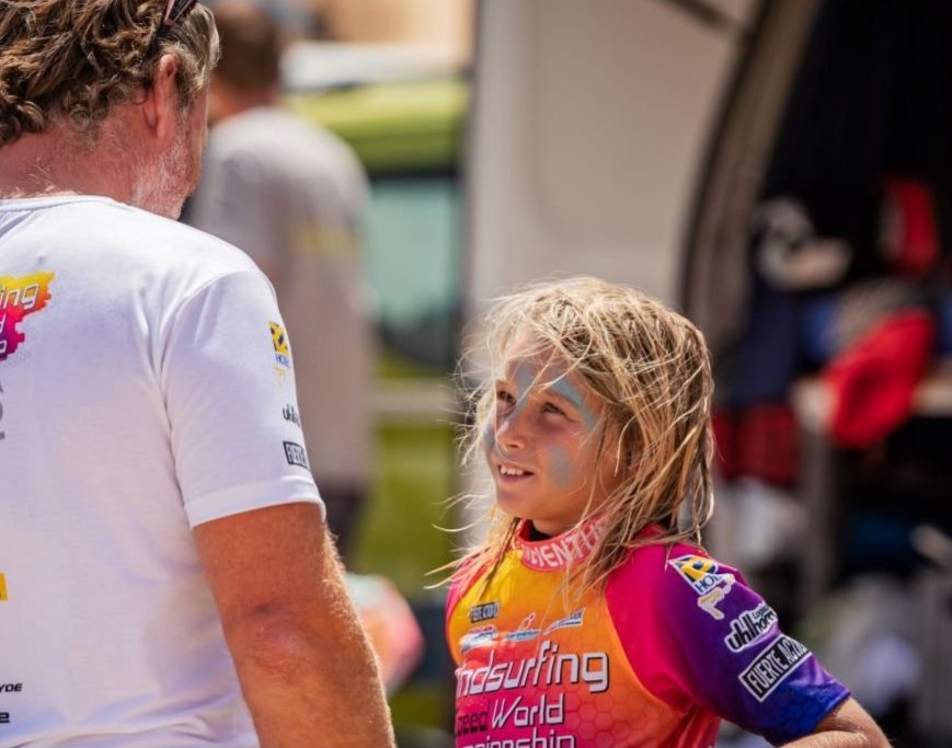 a vase with a feather in it